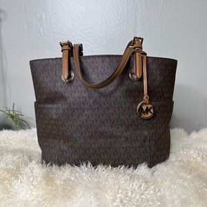Classic Micheal Kors monogram travel tote bag with two side pockets